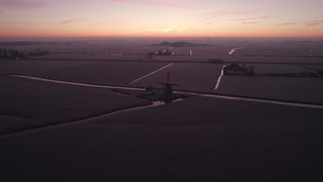 reveal shot of the babuurstermolen tjerkwerd during a colorfull sunrise, aerial