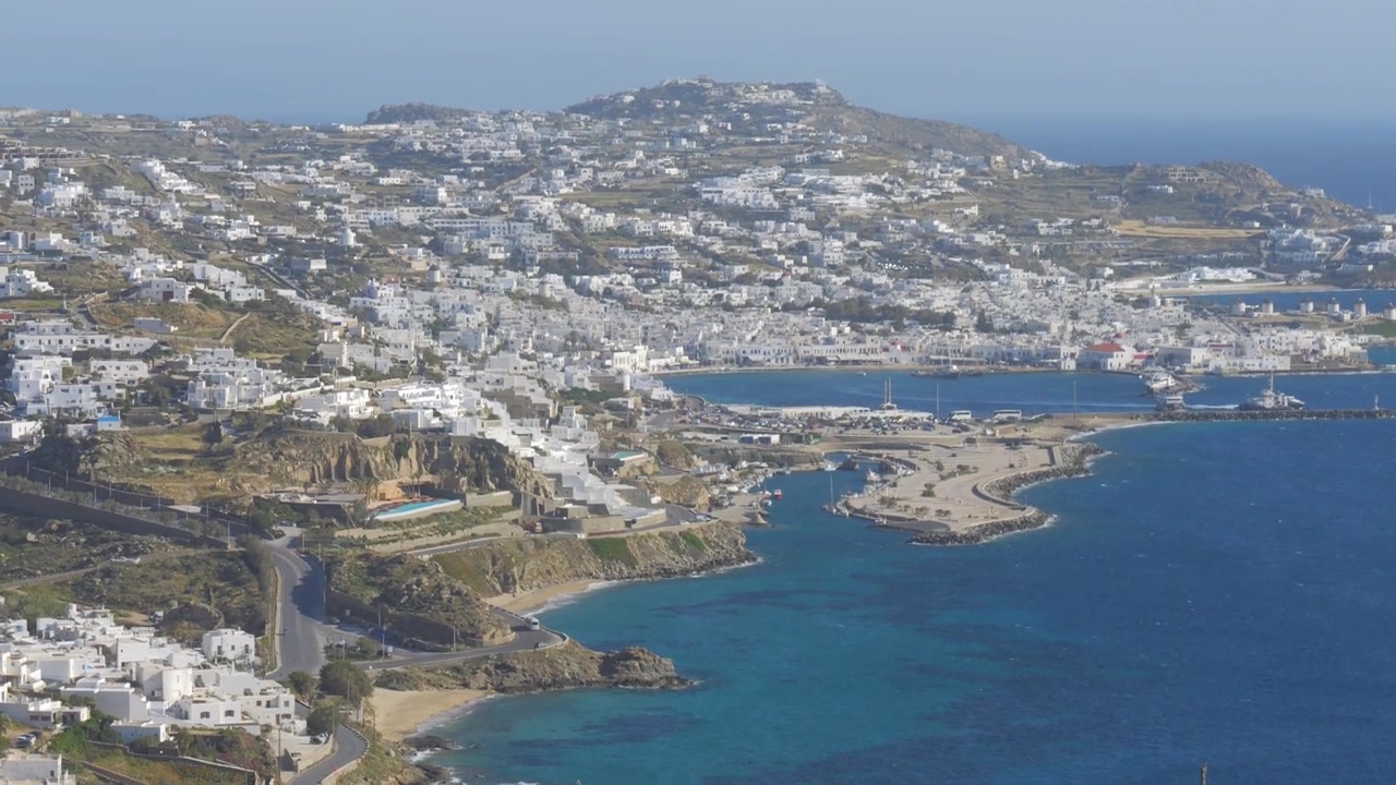 Isola di Mykonos che mostra un porto turistico con barche e una cittadina costiera affacciata sul Mar Egeo