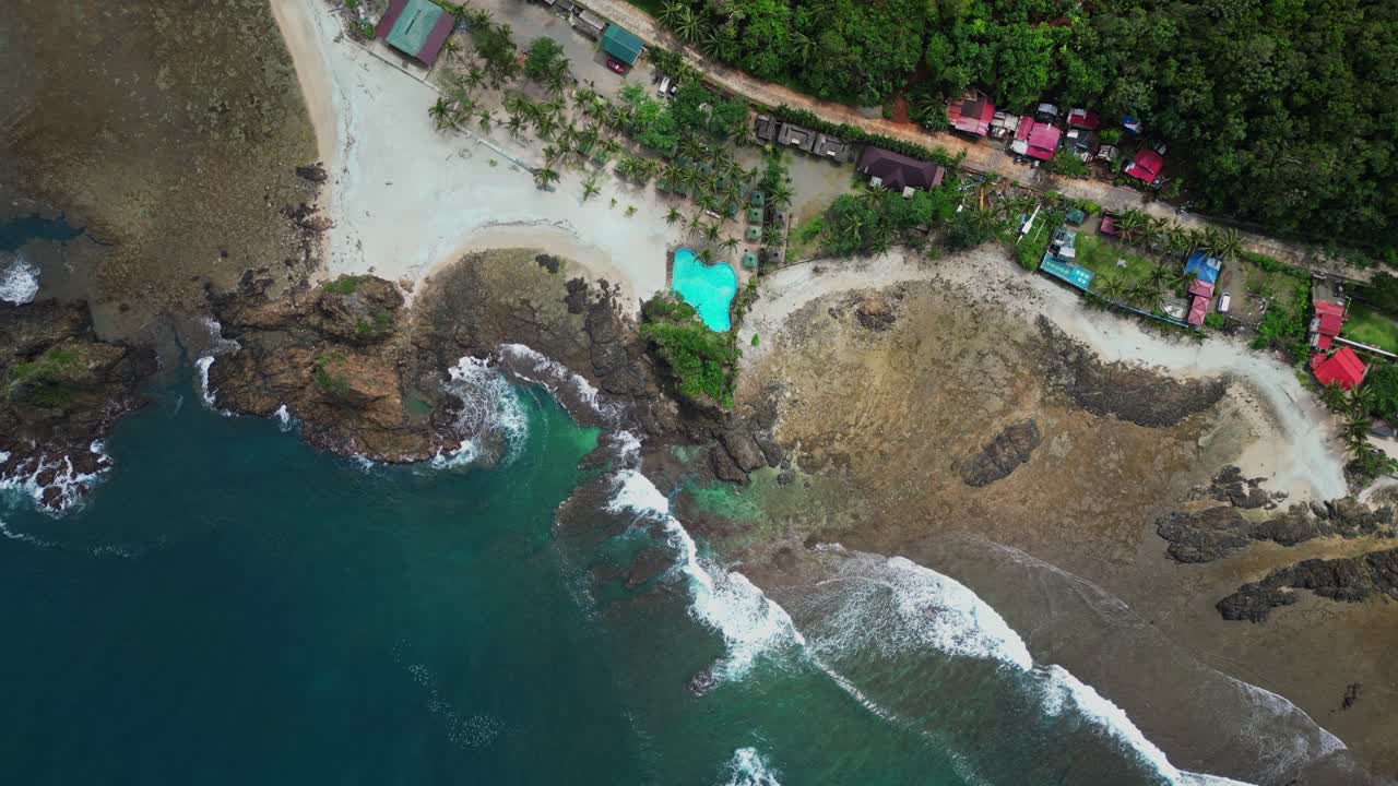 A mesmerizing dolly-out drone shot of Baler unveils the breathtaking beauty of its pristine beaches and crystal-clear waters.