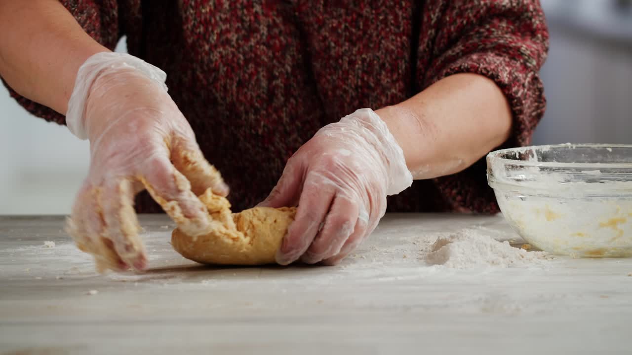 Hands Kneading Dough with Flour on a Kitchen Counter