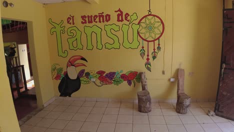 Latin-female-traveler-walks-into-El-Sueno-de-Tansu-hostel-in-Guatemala