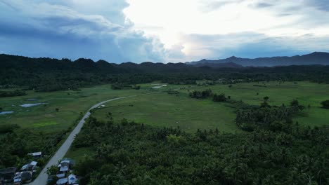 Aerial-pan-of-lush-rainforest-and-storm-clouds,-Catanduanes,-Philippines