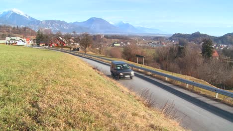 cars drive through the countryside of slovenia or an eastern european nation