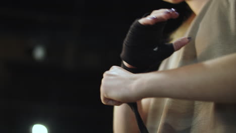 Unknown-woman-preparing-for-boxing-in-sport-club.-Closeup-woman-wrapping-hands