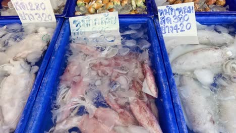 various seafood displayed at a bustling market