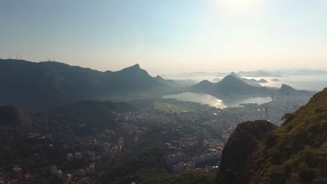 Slow-Aerial-Drone-Shot-Pushing-through-the-Mountains-Revealing-a-City-in-the-Valley