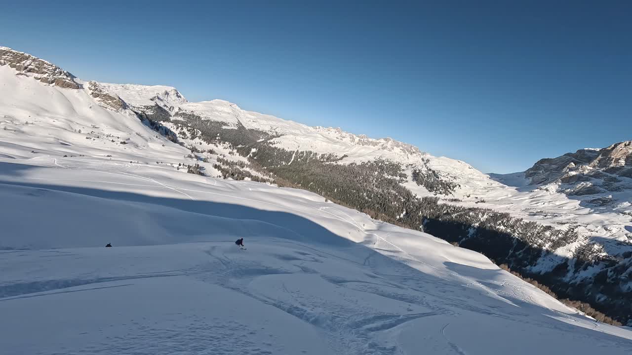 Pov shot of skiier skiing downhill snowy slope in Austria durign sunny day
