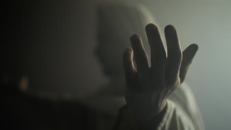 jesus christ, prophet, or biblical figure in prayer and worship with hands lifted in glowing, ambient holy light. perfect for easter resurrection visual.