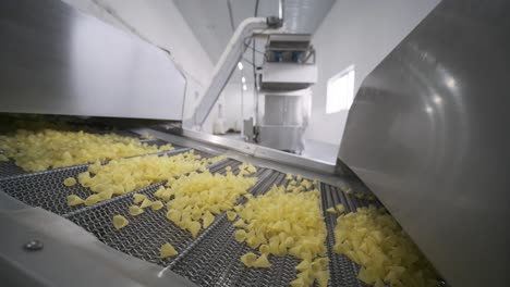 production factory line moves potato snackes. production line of the pasta factory, pasta production