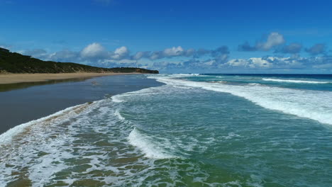 Fly-over-of-stunning-beach-with-crashing-waves