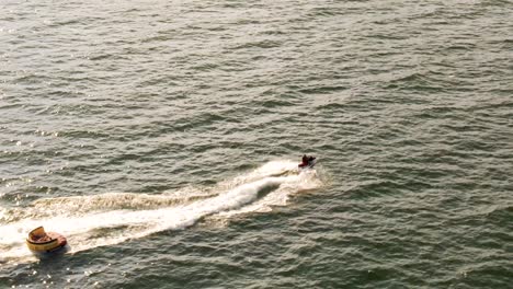 4k cinematic drone stock footage of a person riding a jetski in the black sea in romania