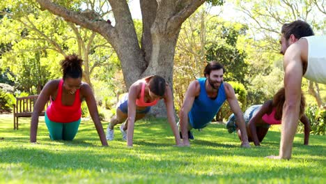 group of friends doing push ups