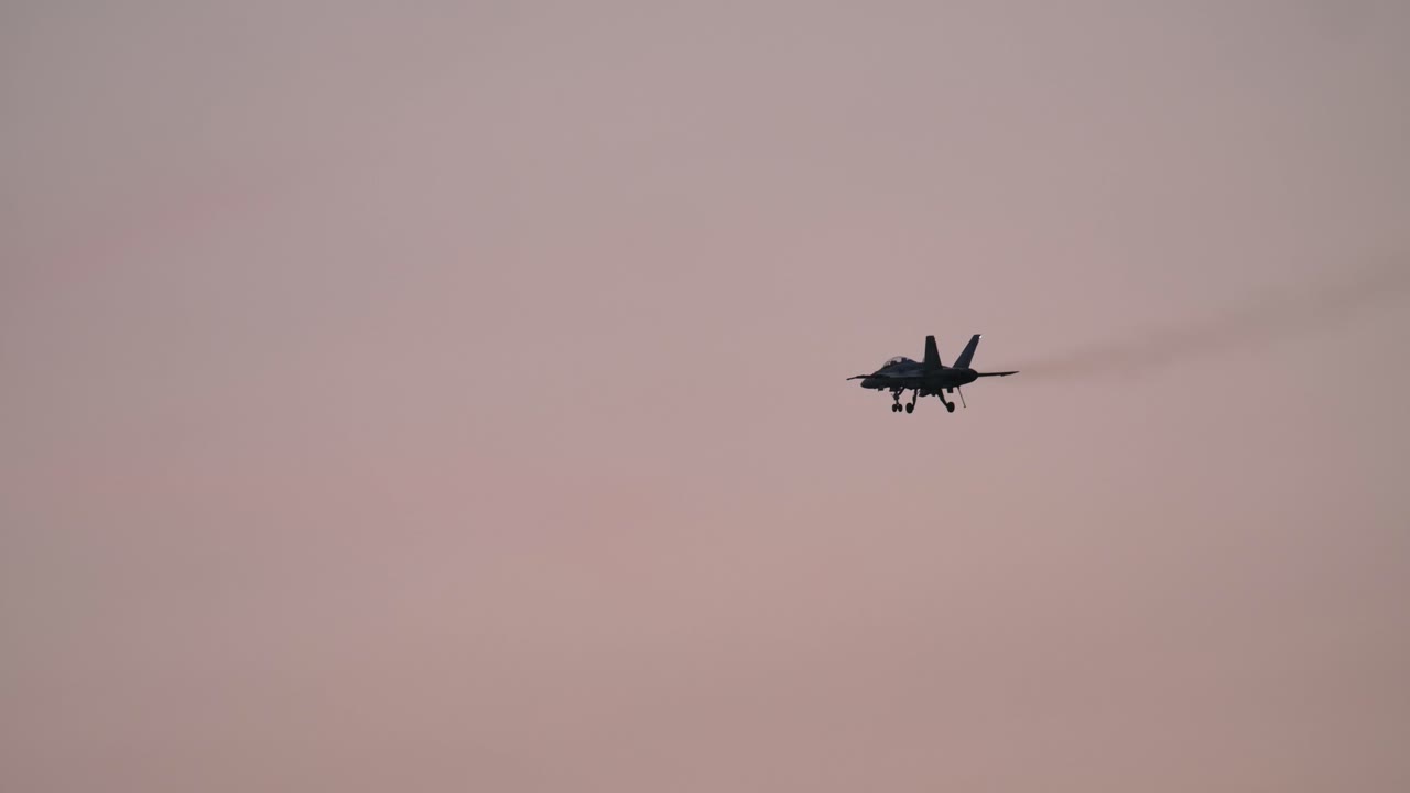 F-18 Fighter Jet with Extended Landing Gear Flying at Dusk SLOMO TRACK