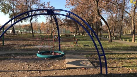 Empty-children-outdoor-jungle-gym-with-web-swing-in-fall-in-4k