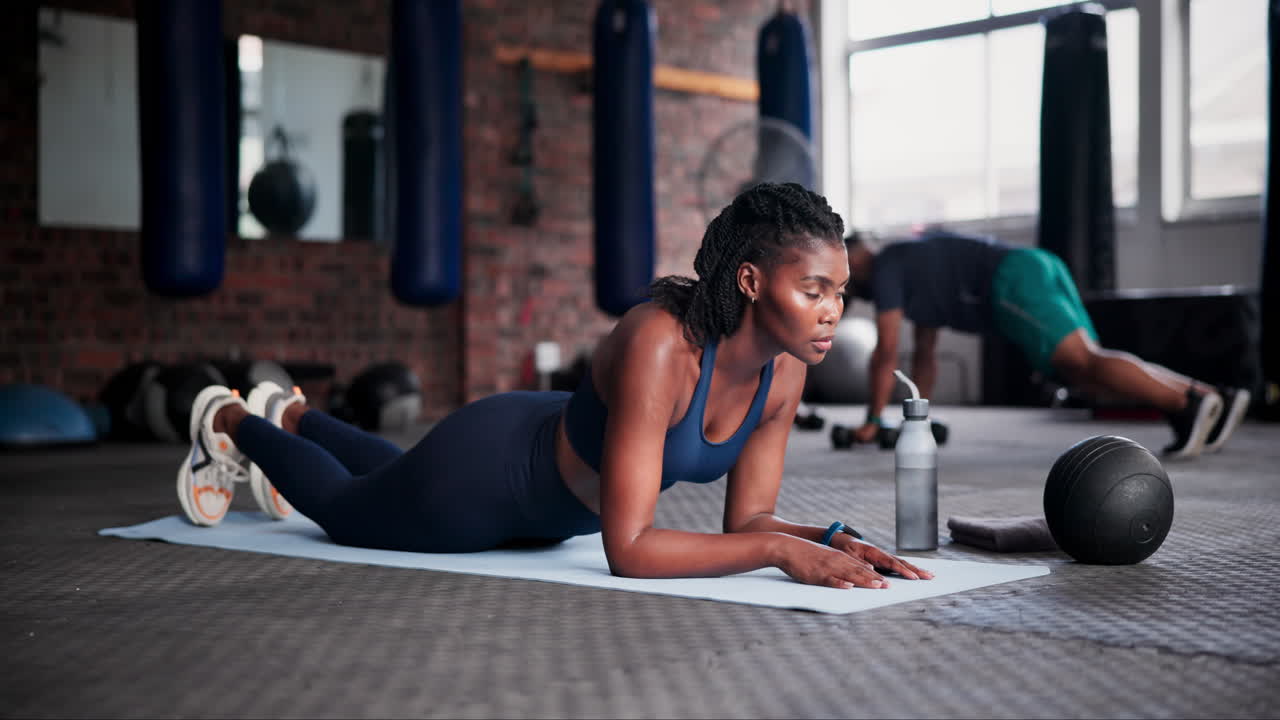 Woman Doing a Plank Exercise in a Gym