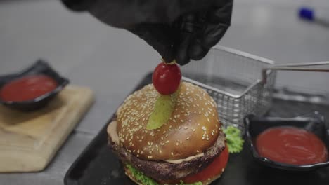 Delicious-hamburger-with-pickle-and-tomato-on-top-in-closeup