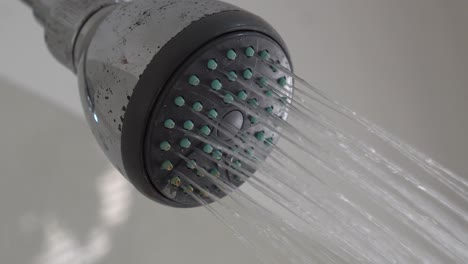 closeup of shower. a shower is a place in which a person bathes under a spray of typically warm or hot water