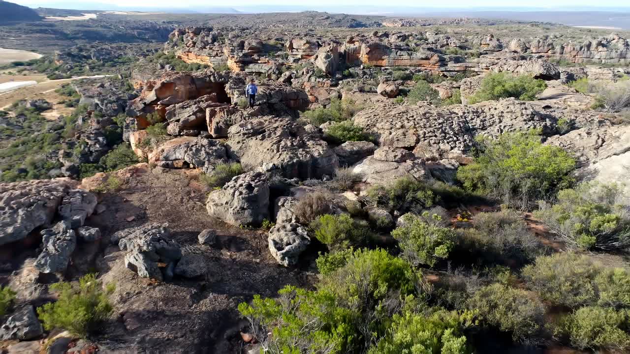 альпинист-мужчина, идущий по скалистой горе 4к