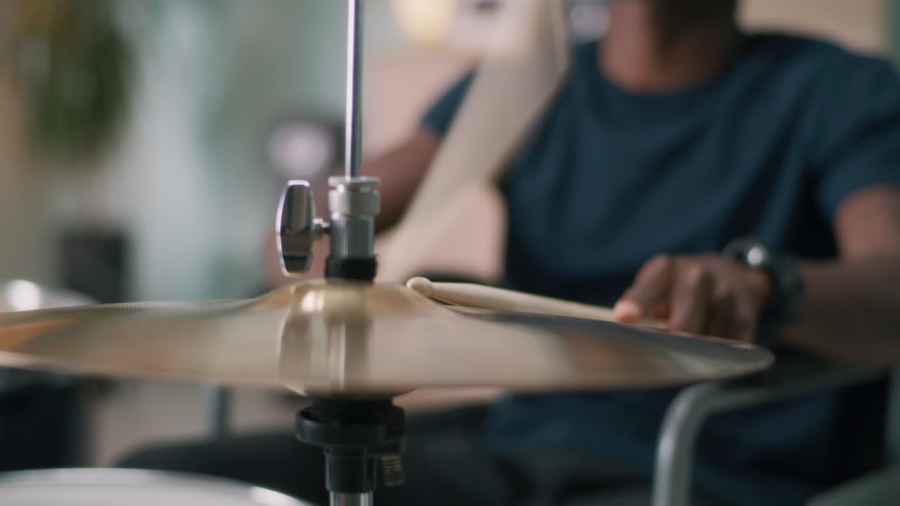 Black male with disability enjoying music and playing drums