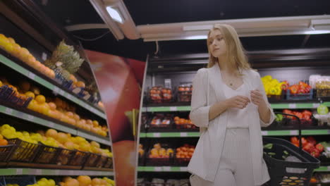 A-beautiful-woman-walks-through-the-supermarket-with-a-basket-in-her-hands-looking-at-the-shelves-of-fruit.-Buying-fresh-fruits-and-vegetables.