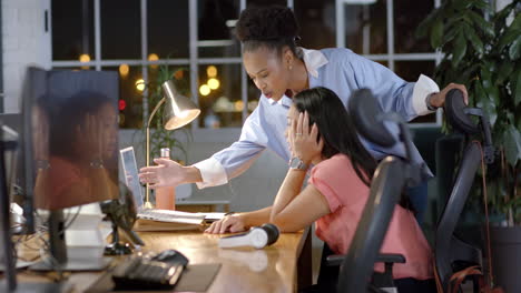 young african american businesswoman assists biracial woman in office