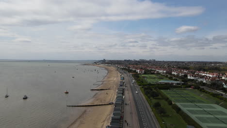 aerial above sandy beach shot. drone over british seascape. 4k stock video aerial view of uk sandy beach and shoreline.
