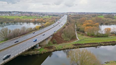 Aerial-drone-cinematic-video-footage-of-the-M1-Motorway-near-the-city-of-Wakefield,-West-Yorkshire,-UK