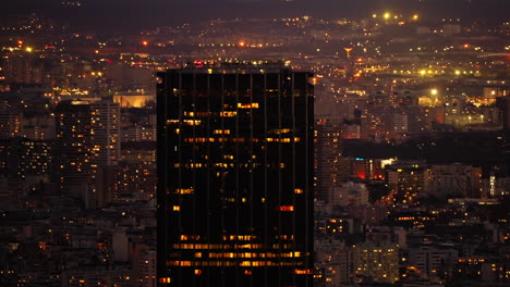 cityscape view from above of the montparnasse skyline, illuminated in the night, in paris, france