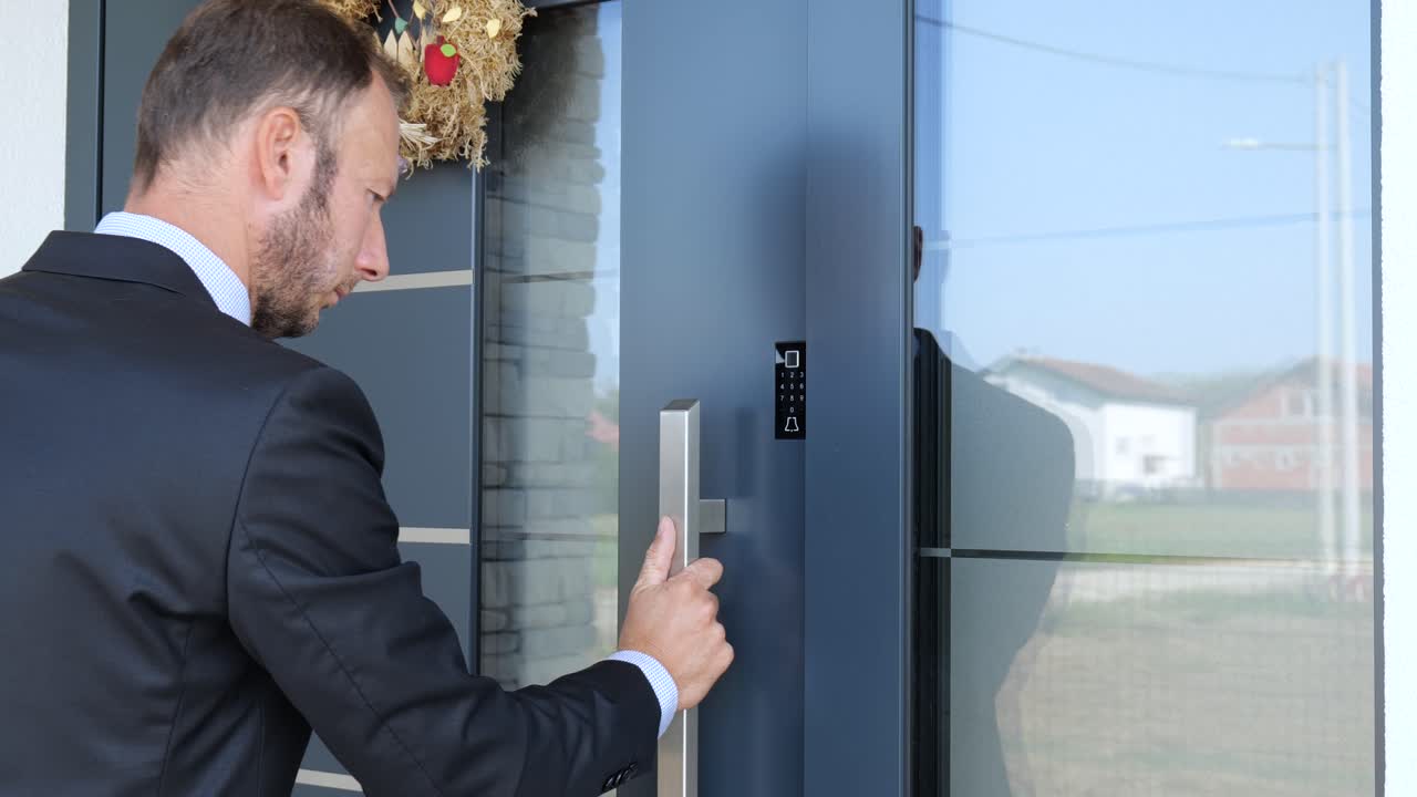 Business man using fingerprint to unlock smart key home entrance