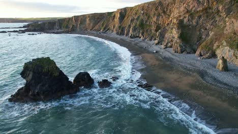 rising tides at the waterford coast at sunset