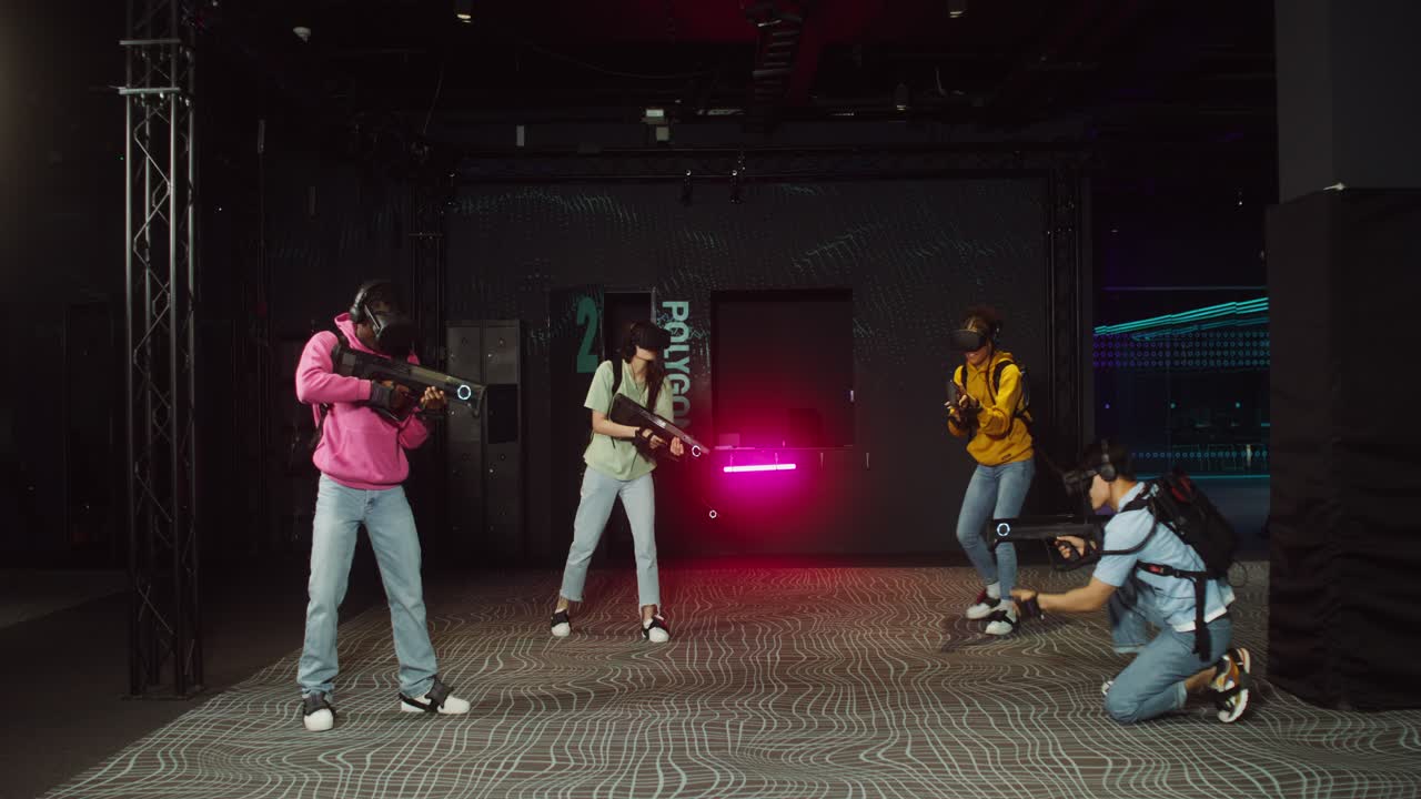Group of friends playing laser tag with VR headsets
