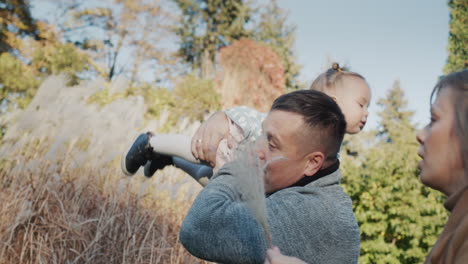 happy father playing with his little daughter in the park, have a good time together