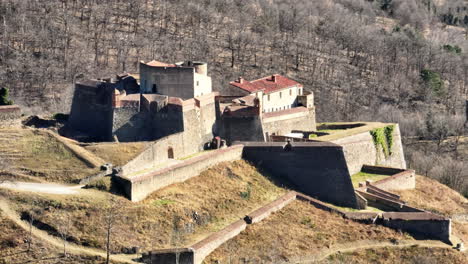 The-historic-Fort-Lagarde-stands-tall,-illuminated-by-the-sun,-in-the-aerial-vie