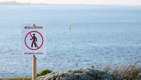 sign indicating no beach access regulations