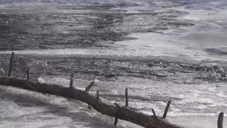 Water-flows-through-a-partially-frozen-creek-in-Canada
