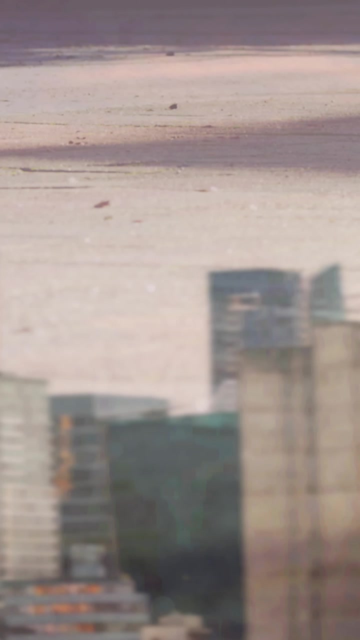 Digital composition of low section of people walking on the street against tall buildings