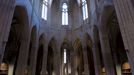 slow establishing shot within a french abbey with wine caskets