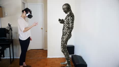 woman picks up an object in virtual reality.