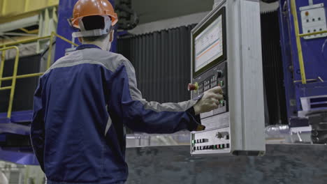 factory worker operating cnc machine