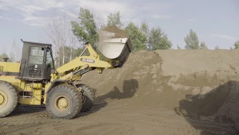 wheel loader loading sand
