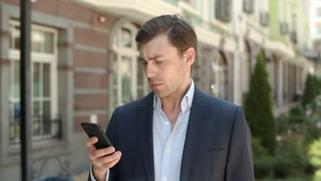 closeup businessman typing messages at street. man using smartphone at street