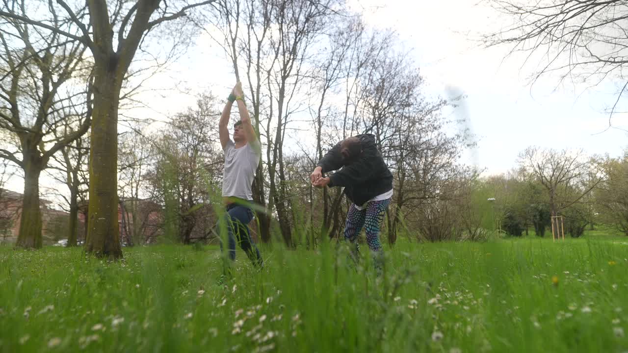 People stretching outdoors in a park