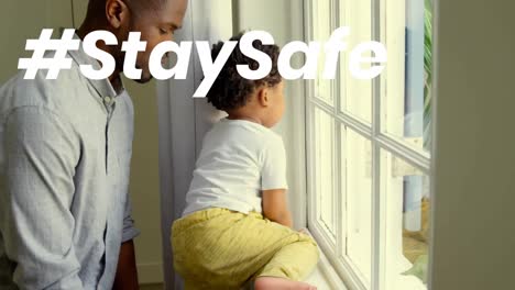 animation of stay safe text over father and child at home