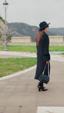 woman walking in the middle of the small town park