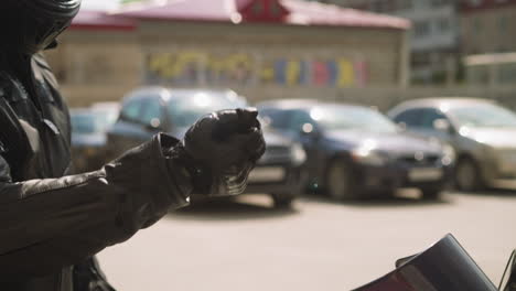 man biker tosses keys of new motorcycle on parking area