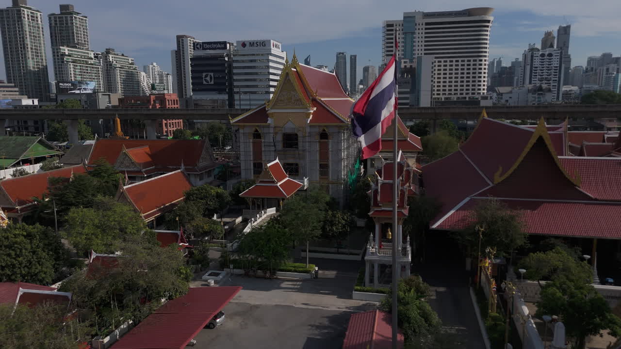 Thai Flag Waving Inside Wat Uthai Tharam Temple Complex In Bangkok, Thailand. Aerial Drone Shot