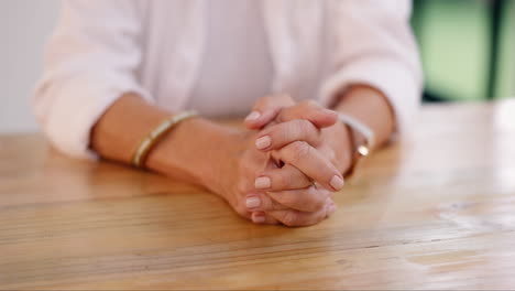 hands resting on a table