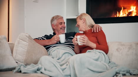 happy senior couple relaxing by the fireplace