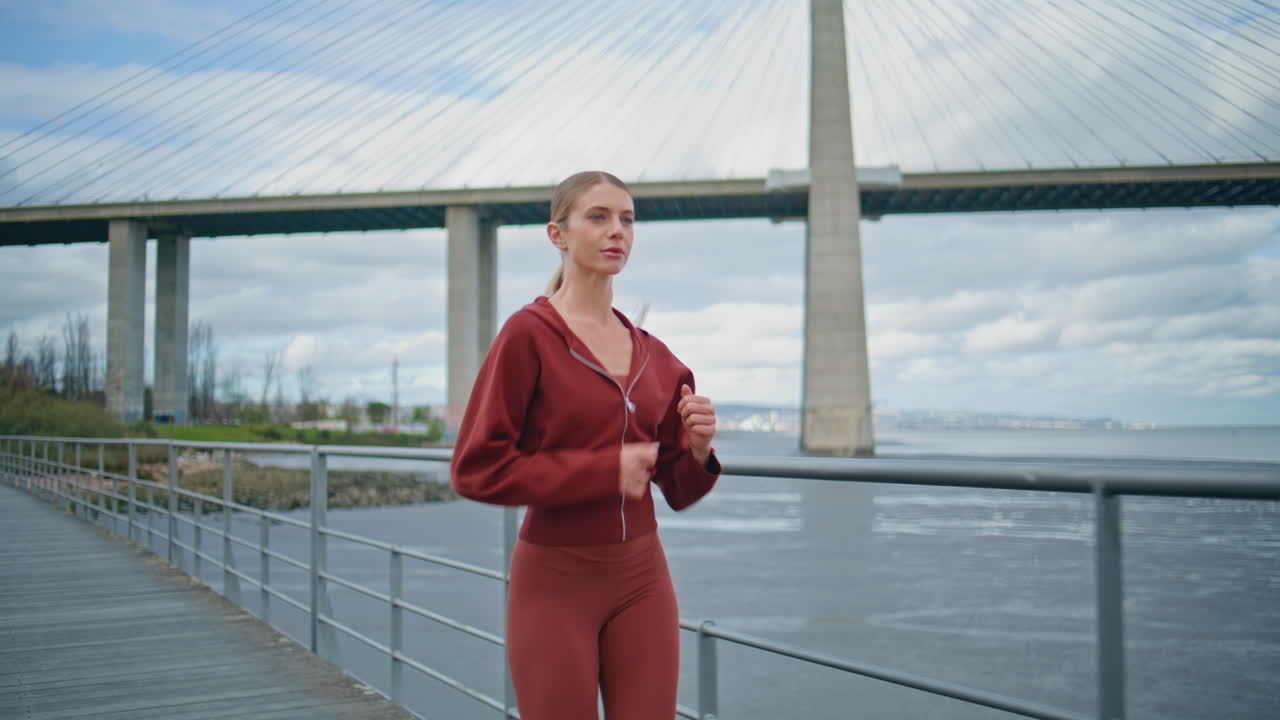 Active woman start running along bay sea. Fitness girl tying sneakers jogging