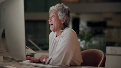 successful businesswoman celebrating at her desk